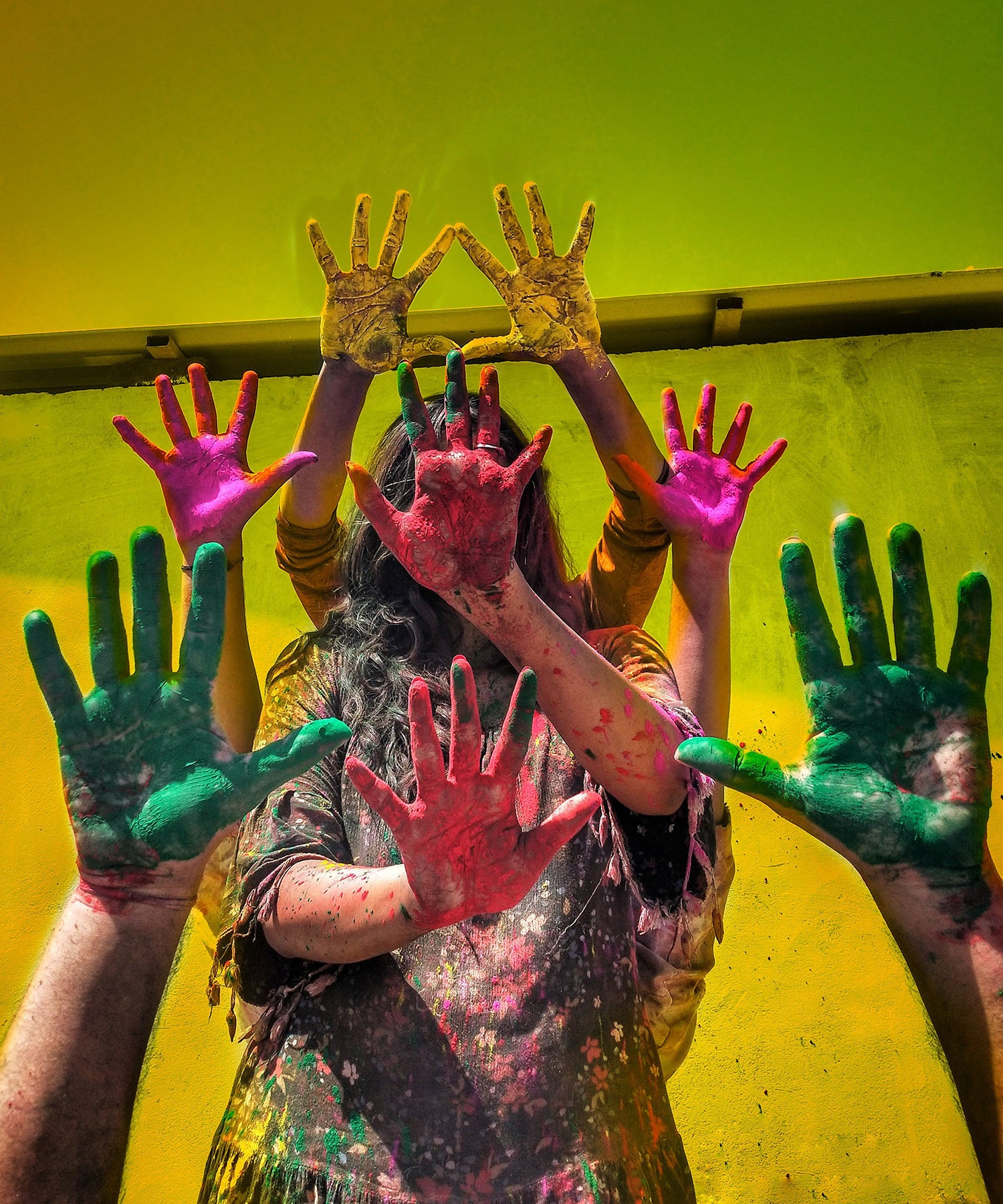 Human hands painted in different colours